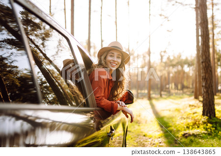 Happy woman in car window. Hair in wind. Road trip. Lifestyle, travel, tourism, nature, active life Happy woman in car window. Hair in wind. Road trip. Lifestyle, travel, tourism, nature, active life 138643865