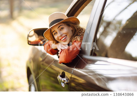 Happy woman in car window. Hair in wind. Road trip. Lifestyle, travel, tourism, nature, active life 138643866