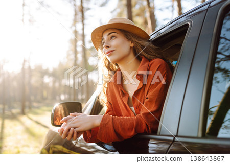 Happy woman in car window. Hair in wind. Road trip. Lifestyle, travel, tourism, nature, active life Happy woman in car window. Hair in wind. Road trip. Lifestyle, travel, tourism, nature, active life 138643867