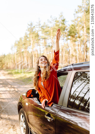 Happy woman in car window. Hair in wind. Road trip. Lifestyle, travel, tourism, nature, active life Happy woman in car window. Hair in wind. Road trip. Lifestyle, travel, tourism, nature, active life 138643876