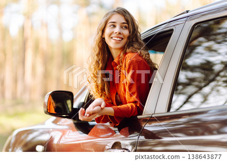 Happy woman in car window. Hair in wind. Road trip. Lifestyle, travel, tourism, nature, active life Happy woman in car window. Hair in wind. Road trip. Lifestyle, travel, tourism, nature, active life 138643877