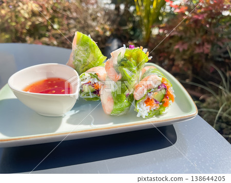 Fresh spring rolls filled with boiled shrimp and vegetables, served with sweet chili sauce. Fresh spring rolls filled with boiled shrimp and vegetables, served with sweet chili sauce. 138644205