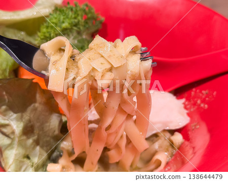 Fresh pasta in basil soup. Close-up of the noodles. Fresh pasta in basil soup. Close-up of the noodles. 138644479