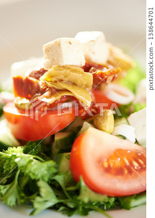 Background, closeup and plate of healthy salad, food and nutrition for detox, lunch diet and eating in cafe. Appetizer, vegan cuisine or dining in restaurant for meal of leafy greens, tomato and feta Background, closeup and plate of healthy salad, food and nutrition for detox, lunch diet and eating in cafe. Appetizer, vegan cuisine or dining in restaurant for meal of leafy greens, tomato and feta 138644701