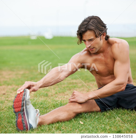 Fitness, stretching and man on field for workout, summer sports and wellness in outdoor training. Exercise, warm up for legs and shirtless athlete on grass for health, muscle and body care commitment 138645058