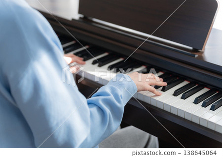 A man playing an electronic piano at home A man playing an electronic piano at home 138645064