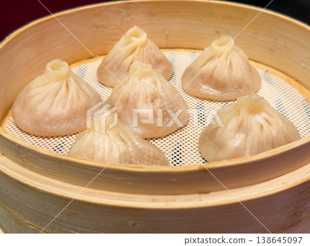 Steamed dishes. Delicious xiao long bao (soup dumplings) overflowing with savory broth. Steamed dishes. Delicious xiao long bao (soup dumplings) overflowing with savory broth. 138645097