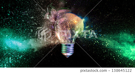 Real Lightbulb exploding into colorful dust Real Lightbulb exploding into colorful dust 138645122