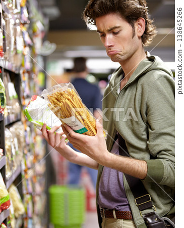 Man, product and comparison choice in supermarket for label difference, nutrition value or grocery shopping. Male person, thinking and decision for shop aisle deal, wholesale price or discount search Man, product and comparison choice in supermarket for label difference, nutrition value or grocery shopping. Male person, thinking and decision for shop aisle deal, wholesale price or discount search 138645266