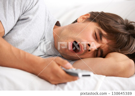 Tv, yawn and tired man in bed with remote control for streaming movies in his home. Fatigue, relax and morning lazy male in a bedroom with television, show or film while on vacation in his house Tv, yawn and tired man in bed with remote control for streaming movies in his home. Fatigue, relax and morning lazy male in a bedroom with television, show or film while on vacation in his house 138645389