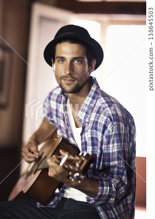 Guitar, portrait or man in home for music, performance or entertainment with sound, rhythm or talent. Learning solo, artist or creative musician playing an instrument for artistic expression alone Guitar, portrait or man in home for music, performance or entertainment with sound, rhythm or talent. Learning solo, artist or creative musician playing an instrument for artistic expression alone 138645503