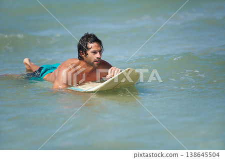 Man, surfing and sea with workout, training and waves with water sport and exercise outdoor of athlete. Surfer, freedom and vacation by the ocean and beach for summer wellness and fitness in nature Man, surfing and sea with workout, training and waves with water sport and exercise outdoor of athlete. Surfer, freedom and vacation by the ocean and beach for summer wellness and fitness in nature 138645504