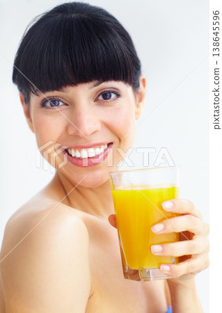 Orange juice, studio portrait and happy woman with glass drink for hydration, liquid fruit detox or natural weight loss. Vitamin C, organic beverage and face of person thirsty on white background Orange juice, studio portrait and happy woman with glass drink for hydration, liquid fruit detox or natural weight loss. Vitamin C, organic beverage and face of person thirsty on white background 138645596