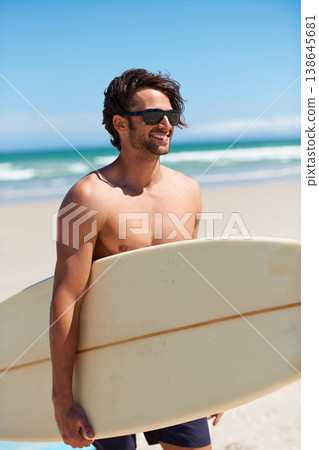 Man, surfing and happy on vacation with sunglasses by the beach and sea for fitness and water sport with smile. Confidence, male person and surfboard for workout and training by ocean with freedom Man, surfing and happy on vacation with sunglasses by the beach and sea for fitness and water sport with smile. Confidence, male person and surfboard for workout and training by ocean with freedom 138645681