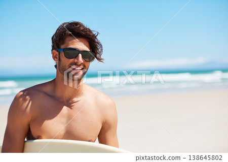 Man smile, surf and vacation with sunglasses by the beach and sea for fitness and water sport with mockup space. Confidence, male person and surfboard for workout and training by ocean with freedom 138645802