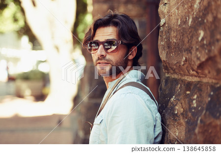 Tourist, sunglasses or man in Italy on holiday, vacation or weekend trip for a adventure in park. Relax, travel or male person with fashion, cool style or freedom sightseeing in urban town on journey 138645858