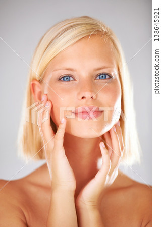 Cosmetics, studio portrait and woman feeling, touch or check smooth skin texture, collagen filler results or skincare treatment. Dermatology self care, anti aging headshot or girl on white background Cosmetics, studio portrait and woman feeling, touch or check smooth skin texture, collagen filler results or skincare treatment. Dermatology self care, anti aging headshot or girl on white background 138645921