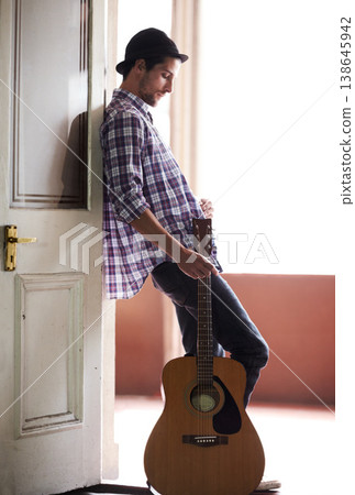 Musician, waiting and man with a guitar, instrument and singer in a music studio. Creative, artist and guitarist standing in home and thinking of performance, equipment or listening to audio of band Musician, waiting and man with a guitar, instrument and singer in a music studio. Creative, artist and guitarist standing in home and thinking of performance, equipment or listening to audio of band 138645942