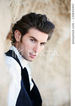 Fashion, nature and portrait of business man for professional clothes, style and elegant outfit. Success, corporate model and face of person by rocks with confidence, pride and formal suit outdoors 138645947