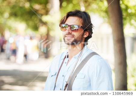 Travel, sunglasses or happy man on holiday, vacation or weekend trip for a fun adventure in Italy. Relax, calm or tourist person with fashion, smile or freedom sightseeing in park, nature or journey 138645969