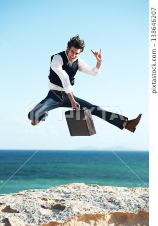 Portrait, ocean and jump with man, briefcase and excited with happiness, holiday and business. Person, employee and consultant with seaside background, beach and action with celebration and vacation Portrait, ocean and jump with man, briefcase and excited with happiness, holiday and business. Person, employee and consultant with seaside background, beach and action with celebration and vacation 138646207