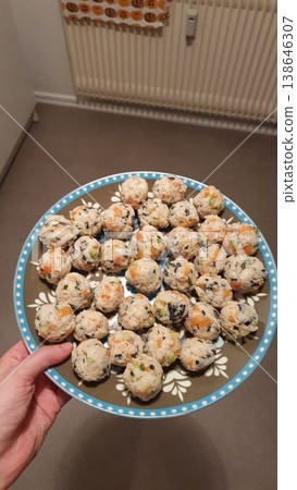Phone photo of a plate of homemade sushi balls. Casual culinary scene showing creative food, colorful ingredients, and everyday cooking at home. 138646307