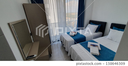 Phone photo of a hotel room in Turkey with blue textiles and towels neatly laid out on the bed. Travel accommodation scene showing hospitality, comfort, and vacation atmosphere. Phone photo of a hotel room in Turkey with blue textiles and towels neatly laid out on the bed. Travel accommodation scene showing hospitality, comfort, and vacation atmosphere. 138646309