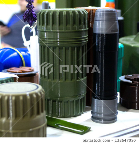 Sealed match container, grenade launcher shot and other elements printed on 3D printer. Prototype of ammunition printed on 3D printer. Innovation modern additive technologies. 3D printing technology Sealed match container, grenade launcher shot and other elements printed on 3D printer. Prototype of ammunition printed on 3D printer. Innovation modern additive technologies. 3D printing technology 138647050