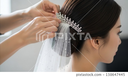 Wedding - Asian Bride Getting Tiara and Pearl Veil Secured by Hairstylist During Bridal Preparation 138647445