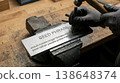 Hands Gripping Metal Punch for Seed Phrase Engraving 138648374