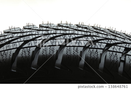 Trade pattern of new car tire with sipes and grooves close up Trade pattern of new car tire with sipes and grooves close up 138648761
