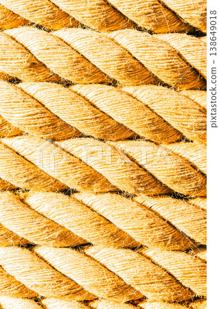 Rough yellow beige rope showing strong twisted threads. Detailed organic cord texture creating a seamless pattern. Twisted natural fiber rope background pattern 138649018