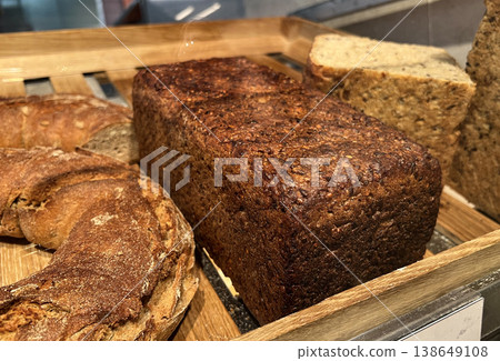 Freshly baked artisan bread loaves displayed in a bakery Freshly baked artisan bread loaves displayed in a bakery 138649108