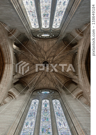 Within the cavernous heart of Liverpool Cathedral, the Under Tower vaulting blooms like a stone flower. Delicate ribs radiate from a central boss, weaving a geometric web against the high shadows. Within the cavernous heart of Liverpool Cathedral, the Under Tower vaulting blooms like a stone flower. Delicate ribs radiate from a central boss, weaving a geometric web against the high shadows. 138649184