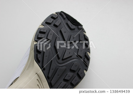 Men's sneaker sole with non-slip rubber insert. Sport shoes for man isolated on white 138649439