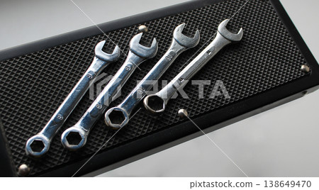 Steel hex wrenches arranged by numbers on a black tool stand flat lay photo 138649470