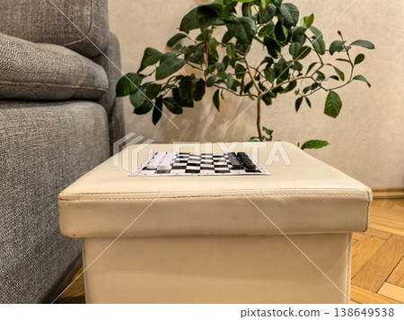 Checkerboard Game on Ottoman 138649538
