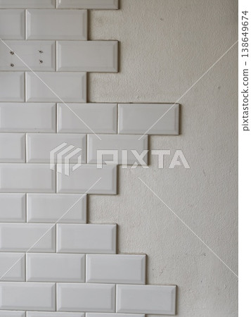 White Subway Tiles Being Installed on Interior Wall Renovation White Subway Tiles Being Installed on Interior Wall Renovation 138649674