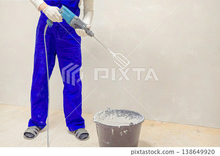 Close up view a worker mixing liquid concrete 138649920