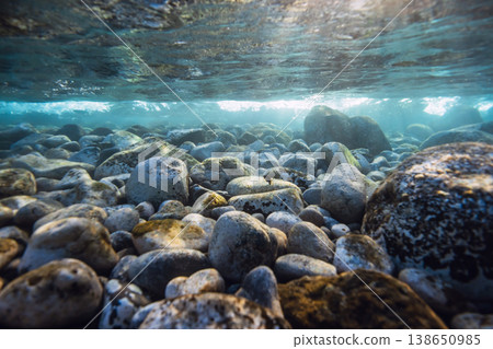 Underwater view of rocky seabed with sunlight rays, clear water and natural marine landscape Underwater view of rocky seabed with sunlight rays, clear water and natural marine landscape 138650985