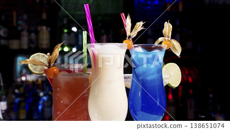 Colorful drinks on a bar counter during a night out at a local bar with friends and music playing in the background Colorful drinks on a bar counter during a night out at a local bar with friends and music playing in the background 138651074