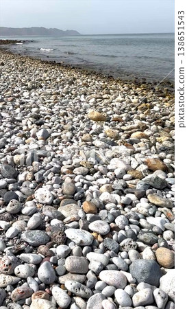 Coastal Rocky Scene. Serene Seaside Landscape Exhibiting Stones And Swirling Clouds In Distance. Peaceful Coastal View Showcasing Uneven Rocks And Moving Clouds Across Horizon Coastal Rocky Scene. Serene Seaside Landscape Exhibiting Stones And Swirling Clouds In Distance. Peaceful Coastal View Showcasing Uneven Rocks And Moving Clouds Across Horizon 138651543