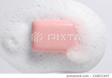 Pink soap with foam on a white background. Pink soap with foam on a white background. 138651847