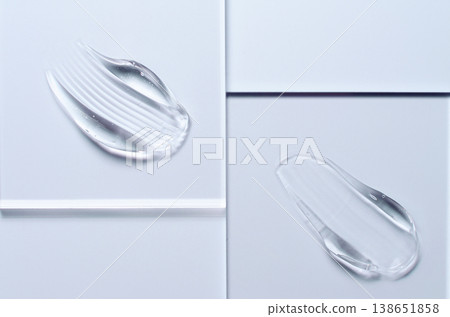 A sample of a transparent cosmetic skin care product on glass. Blue background A sample of a transparent cosmetic skin care product on glass. Blue background 138651858
