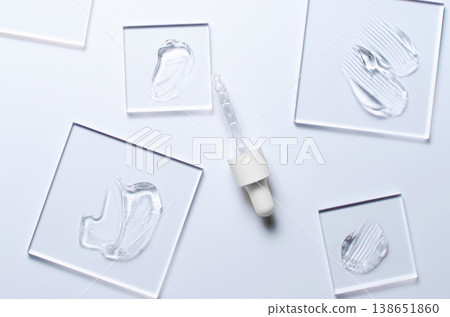 A sample of a transparent cosmetic skin care product on glass. Blue background 138651860