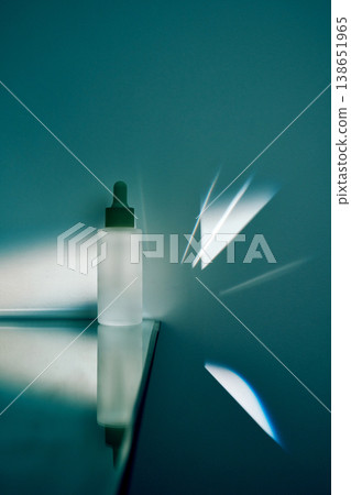 Skincare cosmetic dropper bottle on reflective surface Skincare cosmetic dropper bottle on reflective surface 138651965