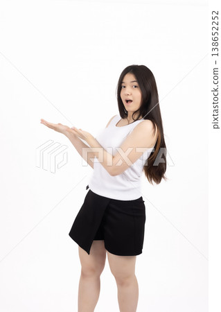 Smiling woman in white top gesturing towards the side Smiling woman in white top gesturing towards the side 138652252