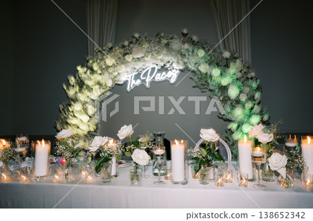 Elegant Floral Reception. Chic Celebration With Lush Floral Decor And Ambient Lighting Elegant Floral Reception. Chic Celebration With Lush Floral Decor And Ambient Lighting 138652342