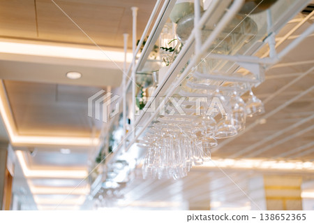 Elegant Bar Ambiance. Sophisticated Scene Featuring Glowing Wine Glasses And Polished Surfaces Elegant Bar Ambiance. Sophisticated Scene Featuring Glowing Wine Glasses And Polished Surfaces 138652365
