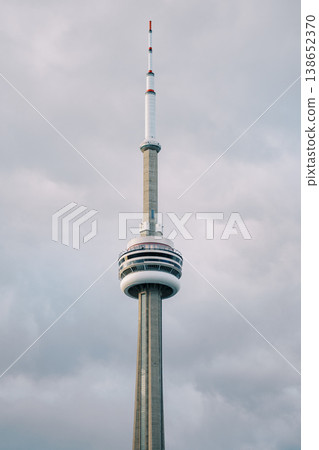 Famous Tower Skyline. Striking Tower Soars Under Somber Overcast Sky With Distant Cityscape 138652370